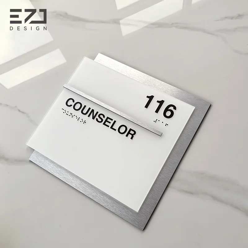 White room identification sign with raised characters and Braille