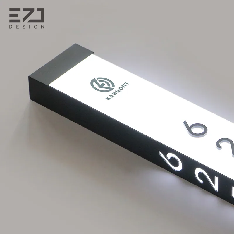 Horizontal view of a white illuminated room sign and visible status controls