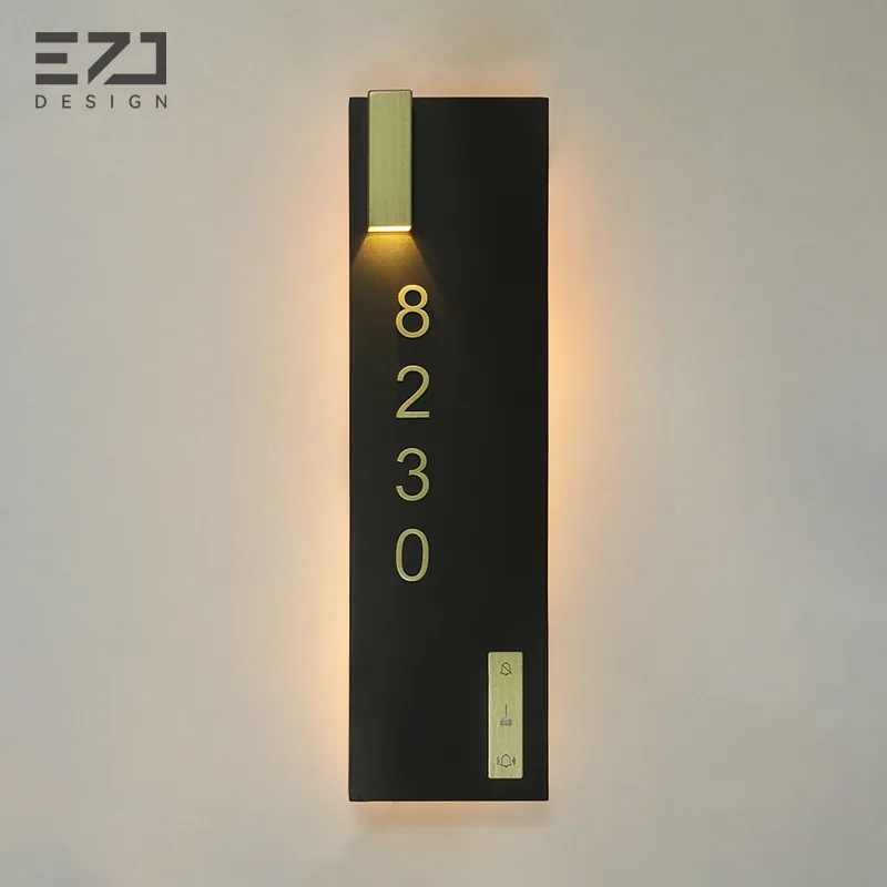 Black and gold electronic hotel door sign with accent lighting