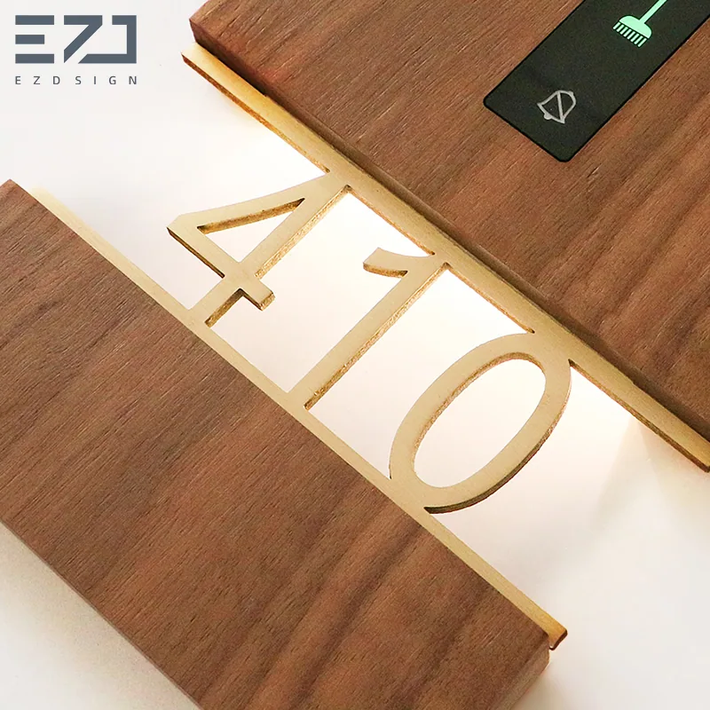 Close view of an illuminated room number on a wood-look electronic door sign