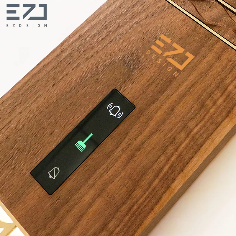 Close view of visible status controls on a wood-look electronic hotel door sign