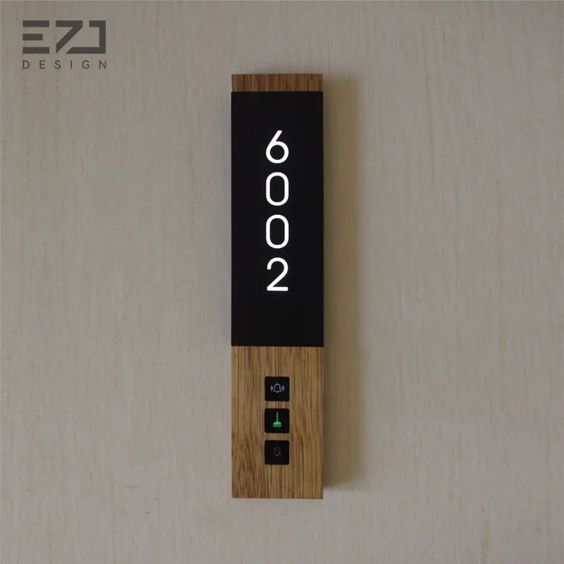 Front view of a light wood-look and black room sign with status controls