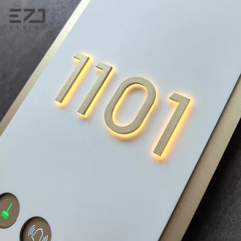Close view of the illuminated room number on an oval hotel door sign