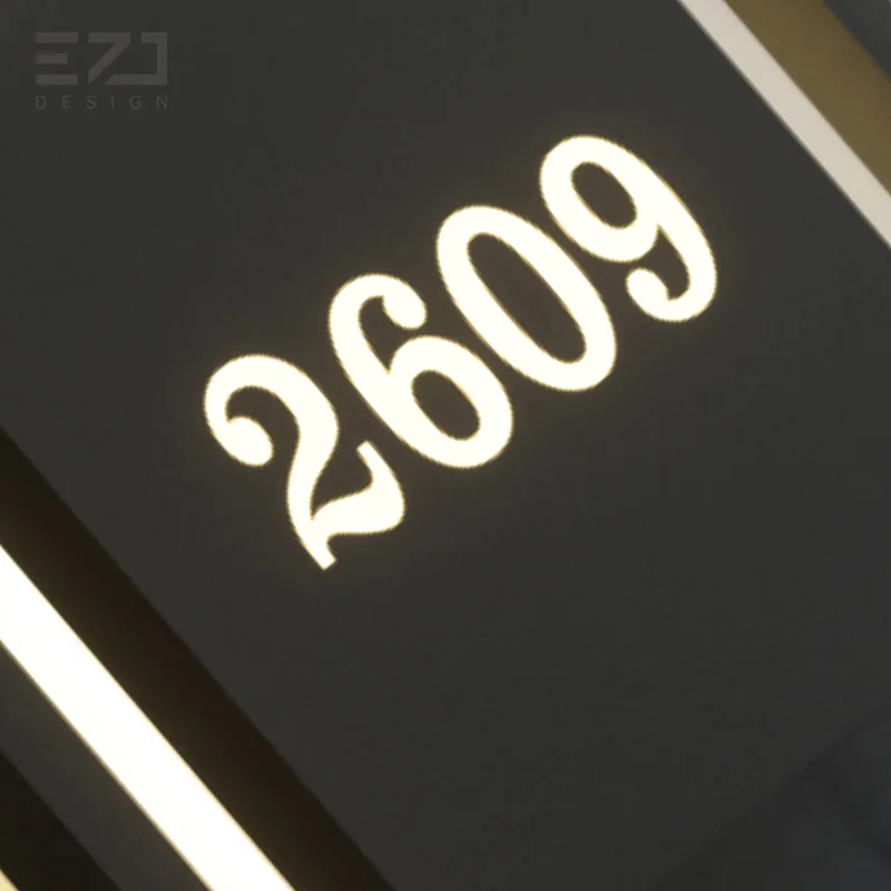 Close view of the illuminated room number on a geometric black hotel door sign